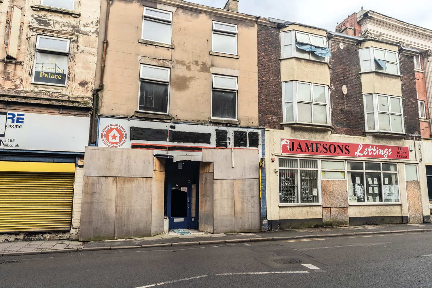 photo of run-down boarded up shopfronts